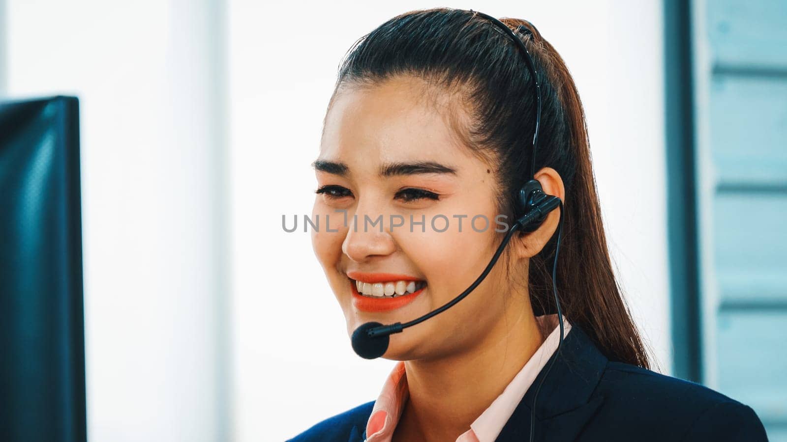 Business people wearing headset working in office to support remote customer or colleague. Call center, telemarketing, customer support agent provide service on telephone video conference call. Jivy