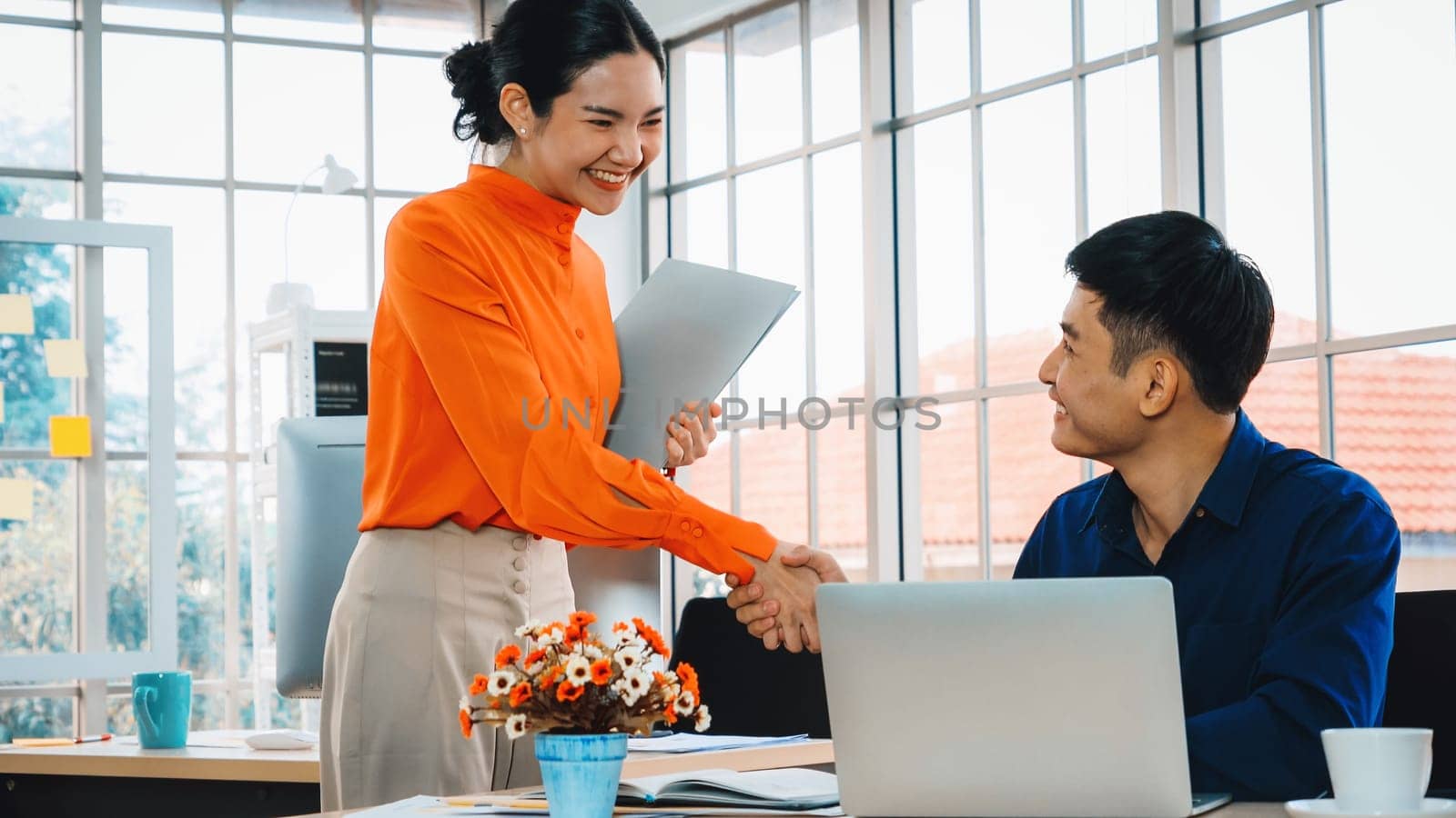 Business people handshake with friend at office showing trust , friendship and success celebration . Jivy