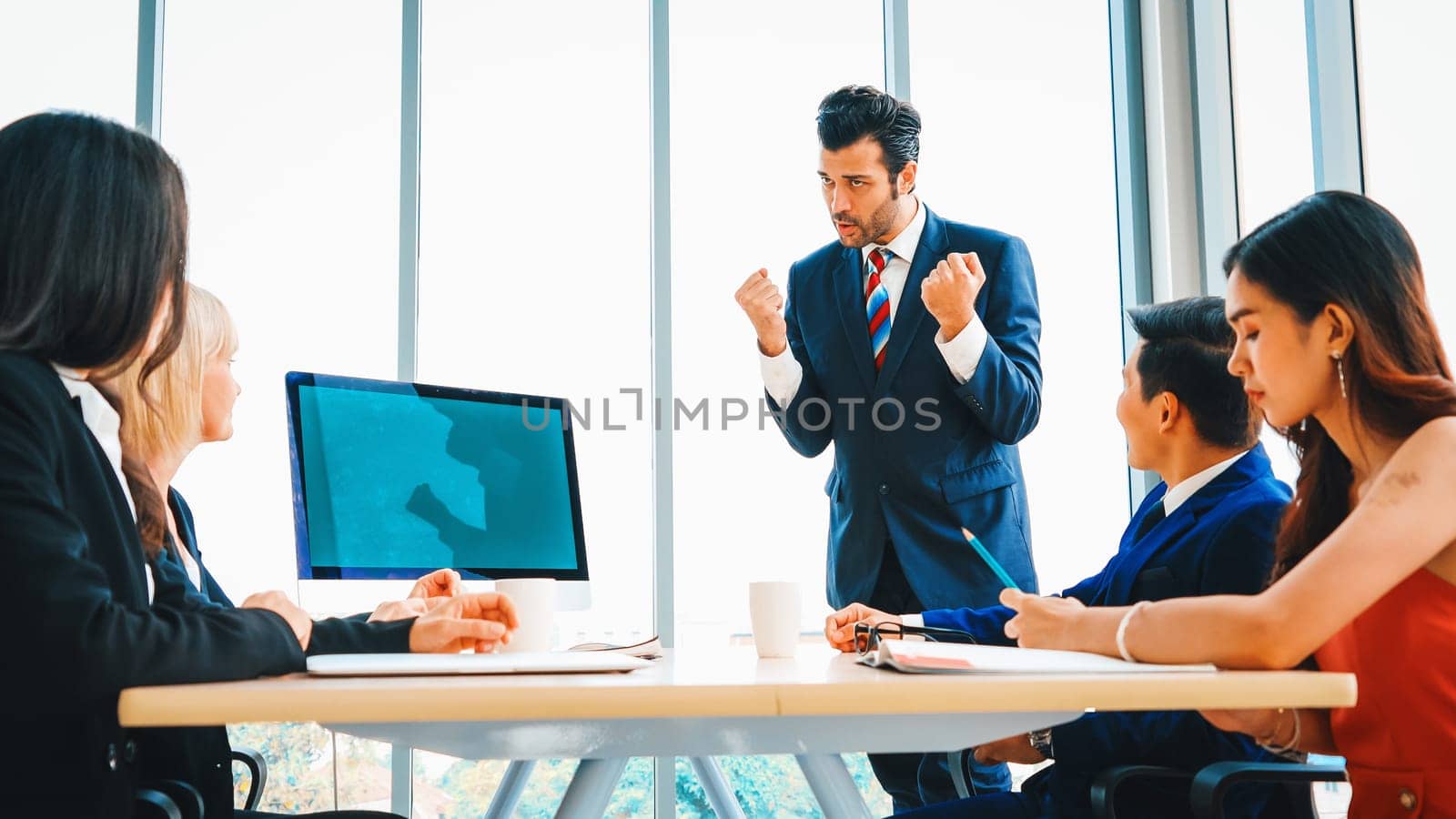 Business people in the conference room with green screen chroma key TV or computer on the office table. Diverse group of businessman and businesswoman in meeting on video conference call . Jivy