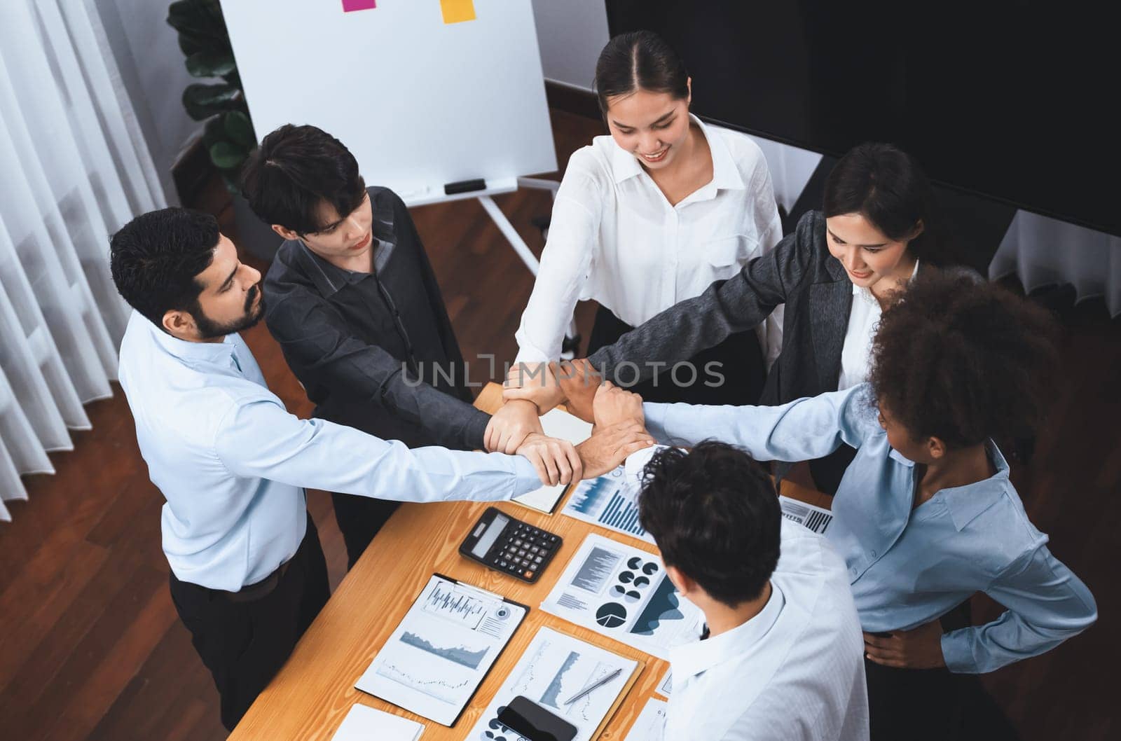 Diverse team of officer worker hold hand in circle at corporate office. Concord by biancoblue