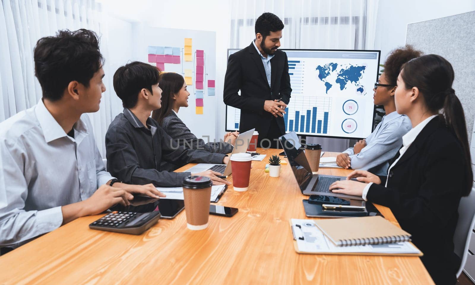 Businessman presenting data analysis dashboard display on TV screen in modern meeting for marketing strategy. Business presentation with group of business people in conference room. Concord