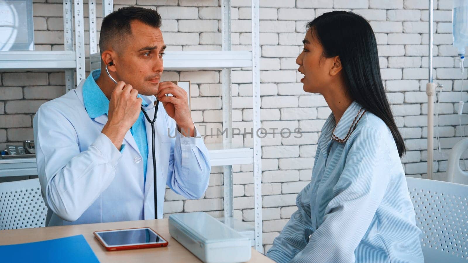 Doctor in professional uniform examining patient at hospital or medical clinic. Health care , medical and doctor staff service concept. Jivy