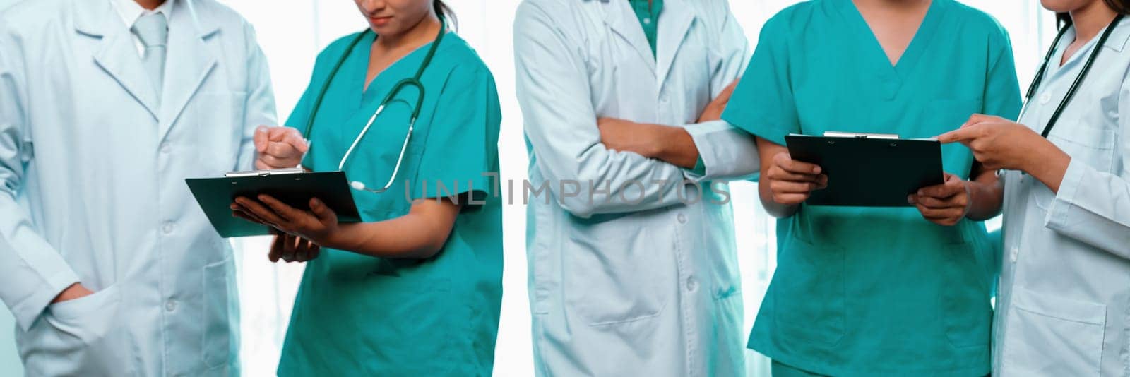 Confident medical staff team with doctor nurse and healthcare specialist professions people in hospital or clinic office. Medical and healthcare community in panoramic banner. Neoteric