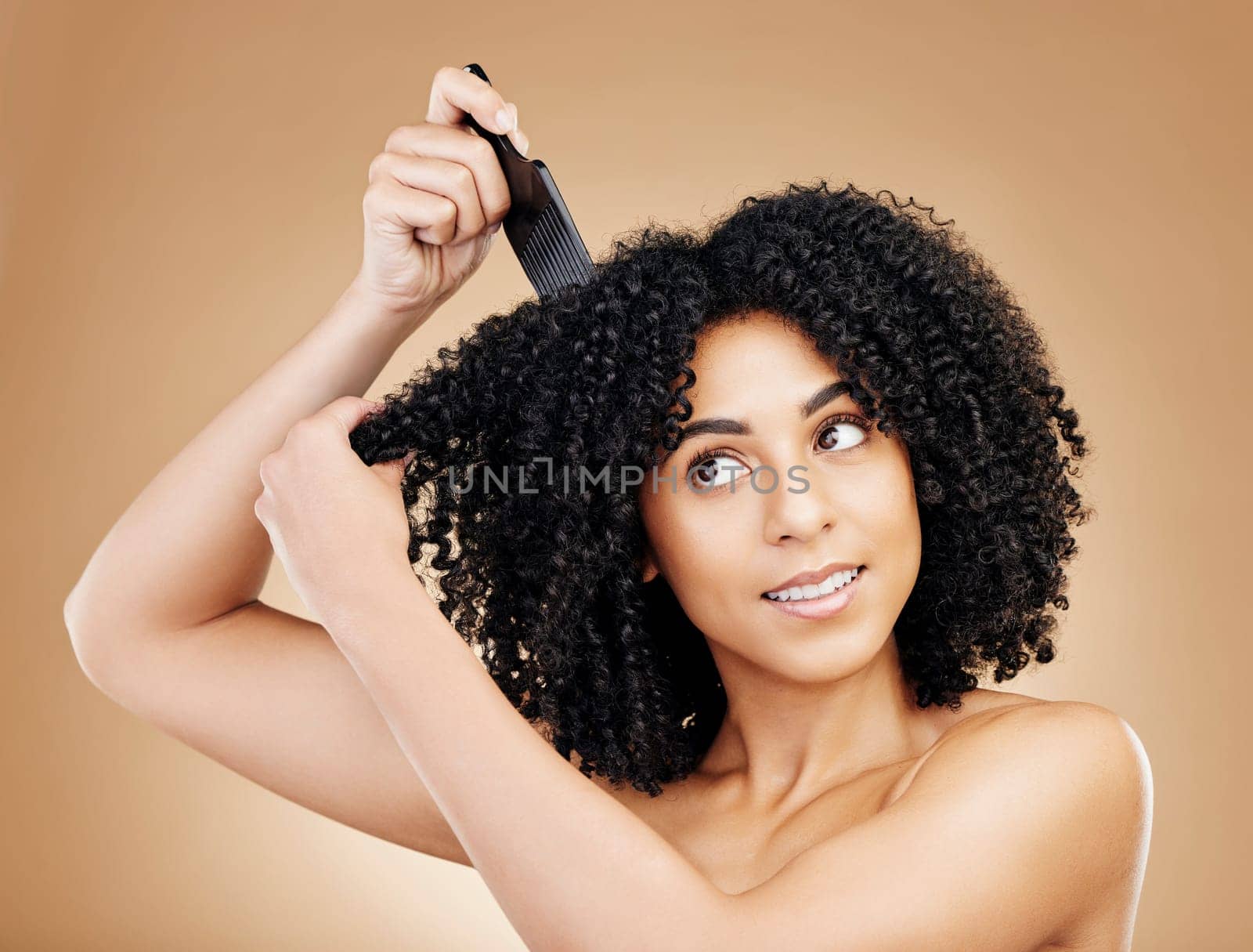 Hair care, afro and woman with a comb, beauty and treatment on a brown background. Person, girl and model with salon grooming, volume or shine with glow, wellness and aesthetic with texture and clean.