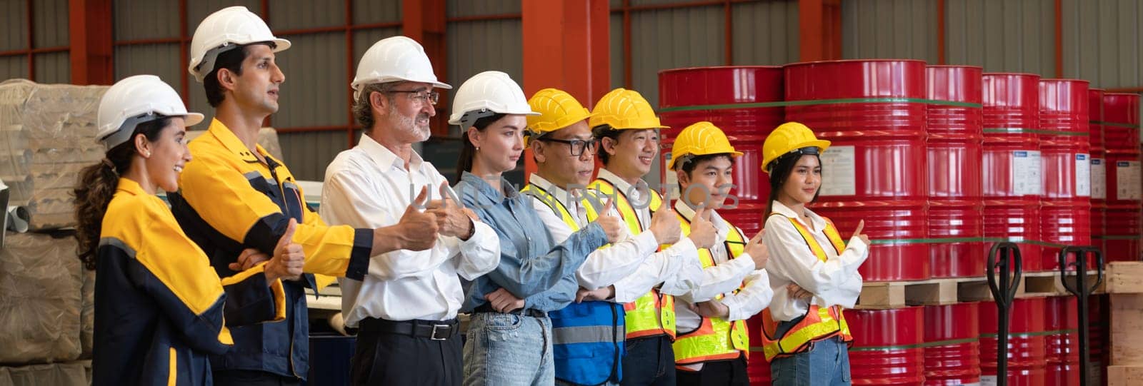 Confident and smiling lineup of factory worker, engineer, manager and foreman stand on-site within heavy industrial manufacturing factory with sense of teamwork and determination Panorama Exemplifying