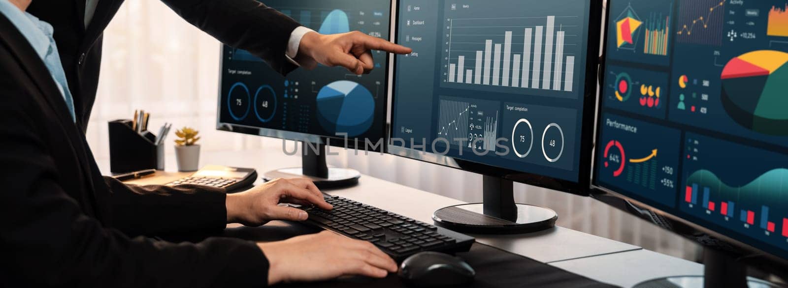 Analyst working on data analysis or BI dashboard on computer monitor. Business team analyzing financial data by Fintech in corporate office for business marketing and strategy planning. Trailblazing