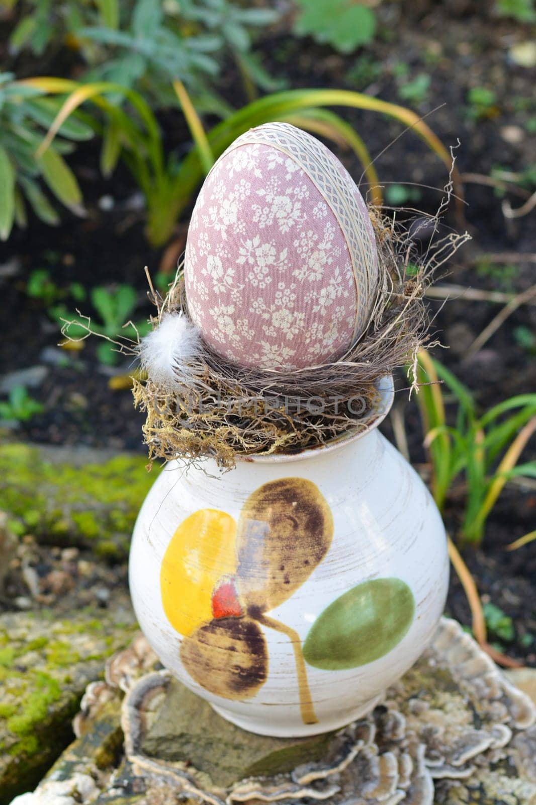 Easter egg in vase at a garden.