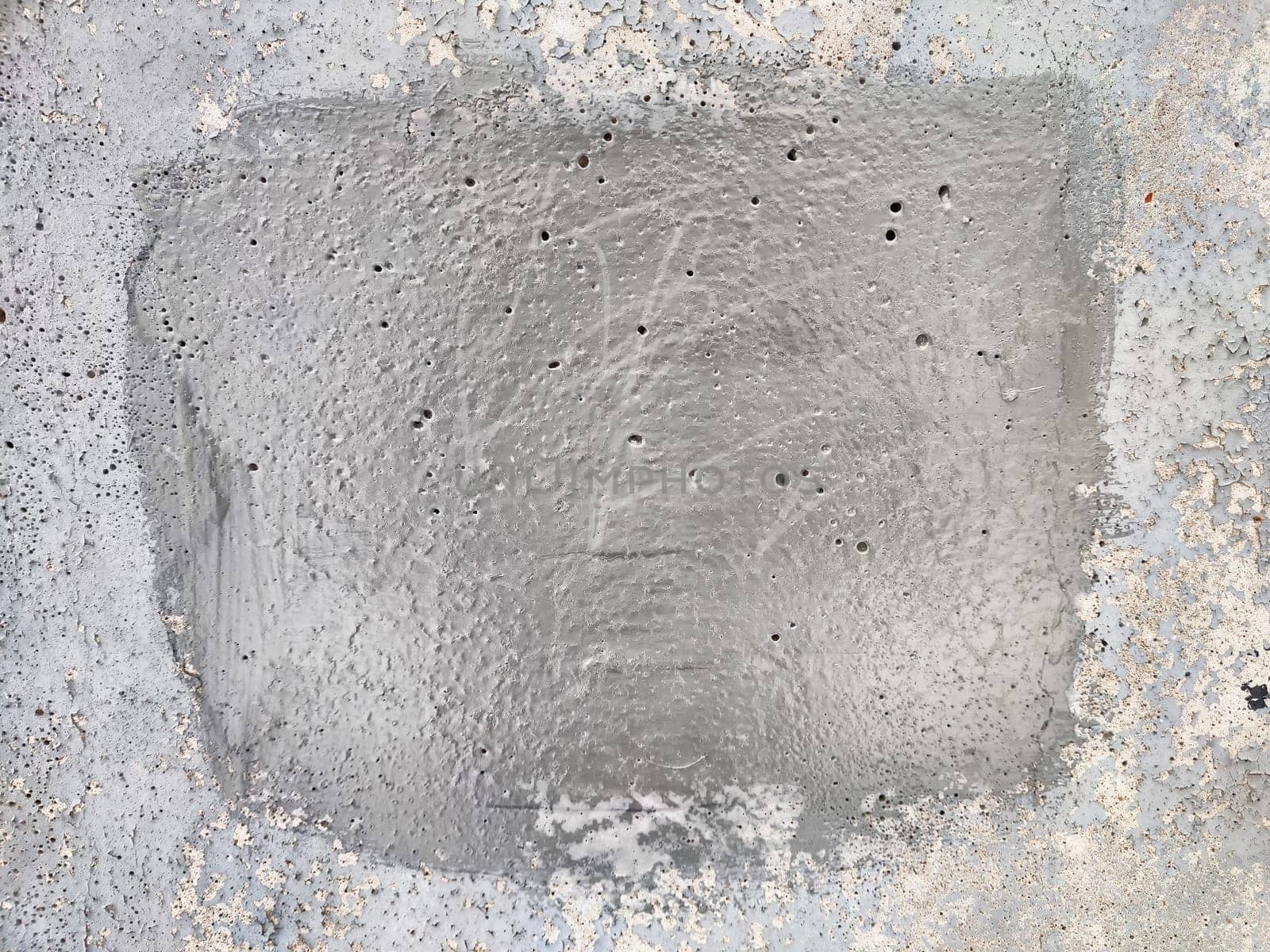 A smooth, even gray surface with visible texturing is prepared for further work at a construction site, showcasing craftsmanship and precision.