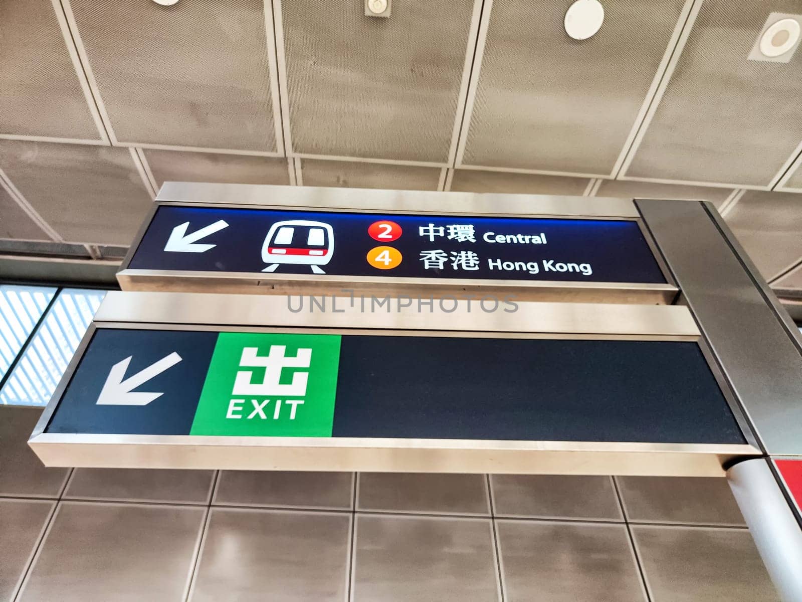 Hong Kong, China - April 09, 2024 - Passengers crowd the busy subway station in Hong Kong, following directional signs to Central and Hong Kong exits.
