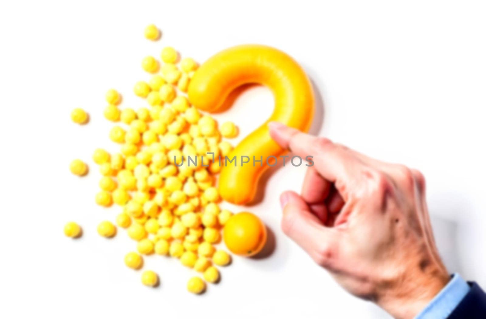 A hand gently touches a large yellow question mark surrounded by vibrant yellow balls, symbolizing inquiry about difficulties and solutions.. Blurred picture