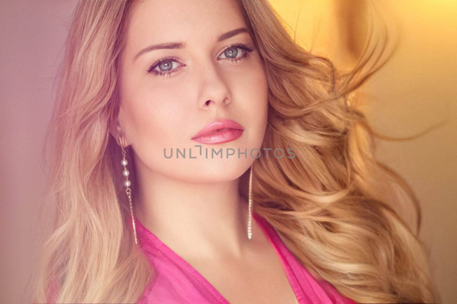 Woman with blue eyes and long, voluminous blonde hair styled in soft curls, wearing pink dress and elegant earrings, dreamy and feminine look idea
