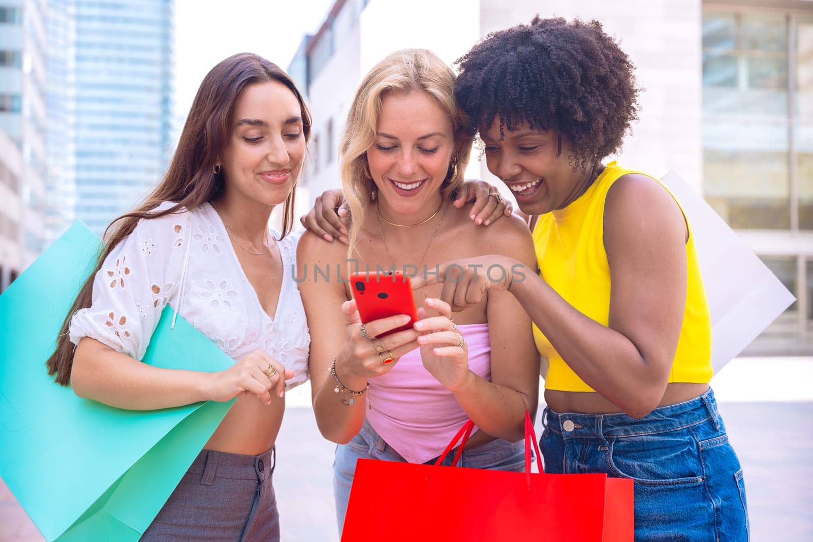 A group of three joyful women cheering and celebrating while looking at a smartphone. A vibrant and fun moment showcasing friendship, happiness, and modern connections.
