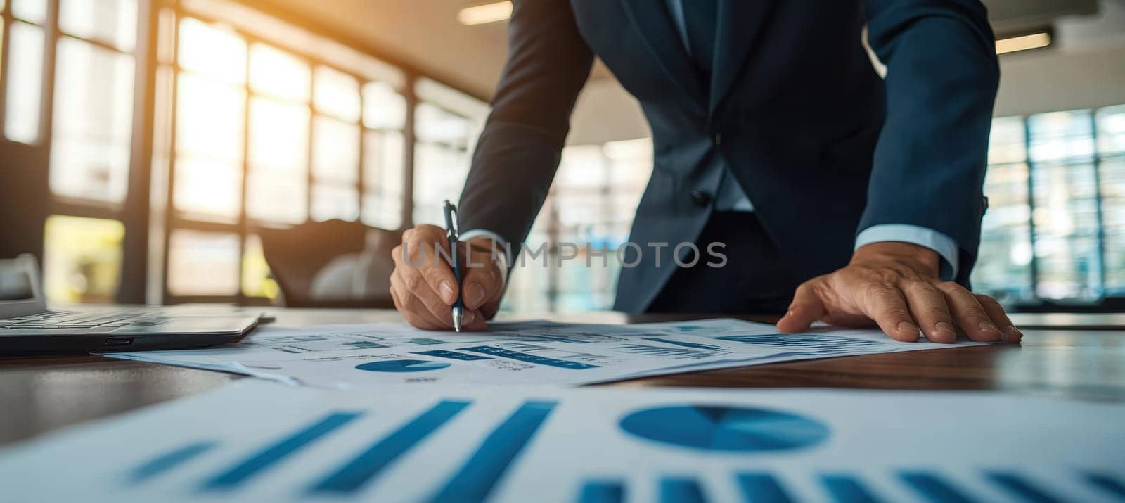 A finance professional in smart business attire leans over a desk reviewing financial documents in a modern, naturally lit office space. the scene suggests diligent analysis, strategic planning, and insights into business growth and financial objectives.