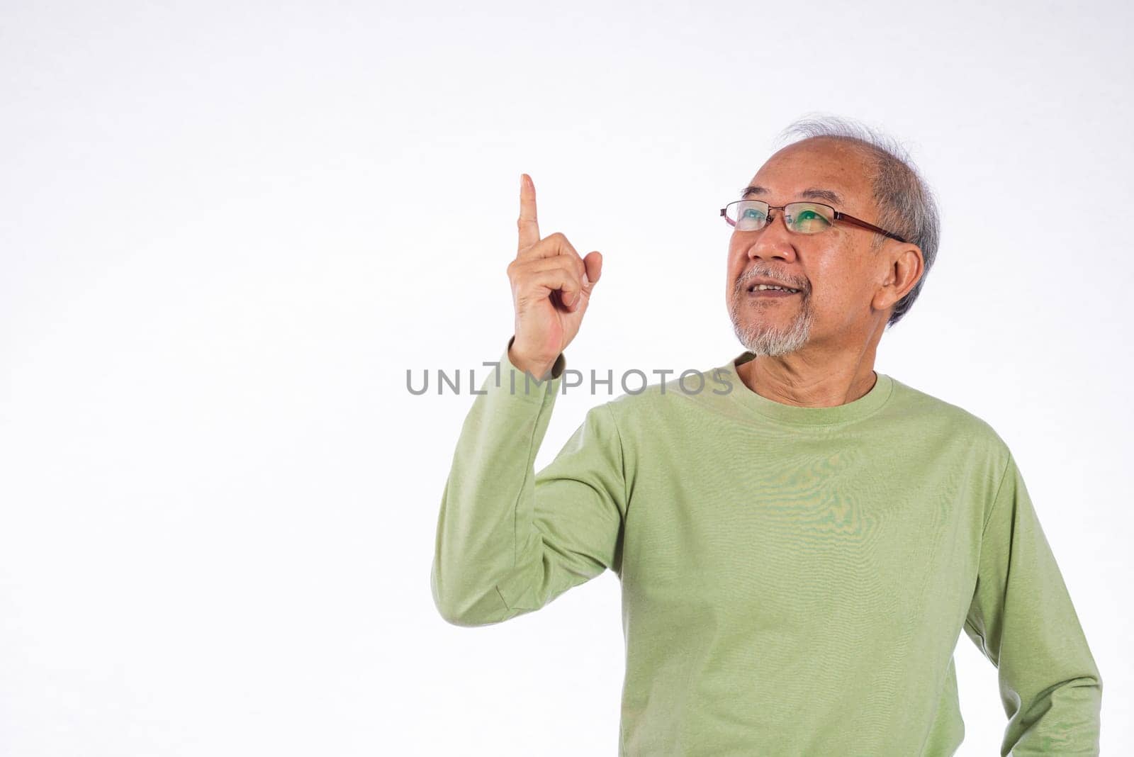 Portrait Asian grey haired with glasses senior man point index fingers to space studio shot isolated on white background, elderly old man pointing finger up