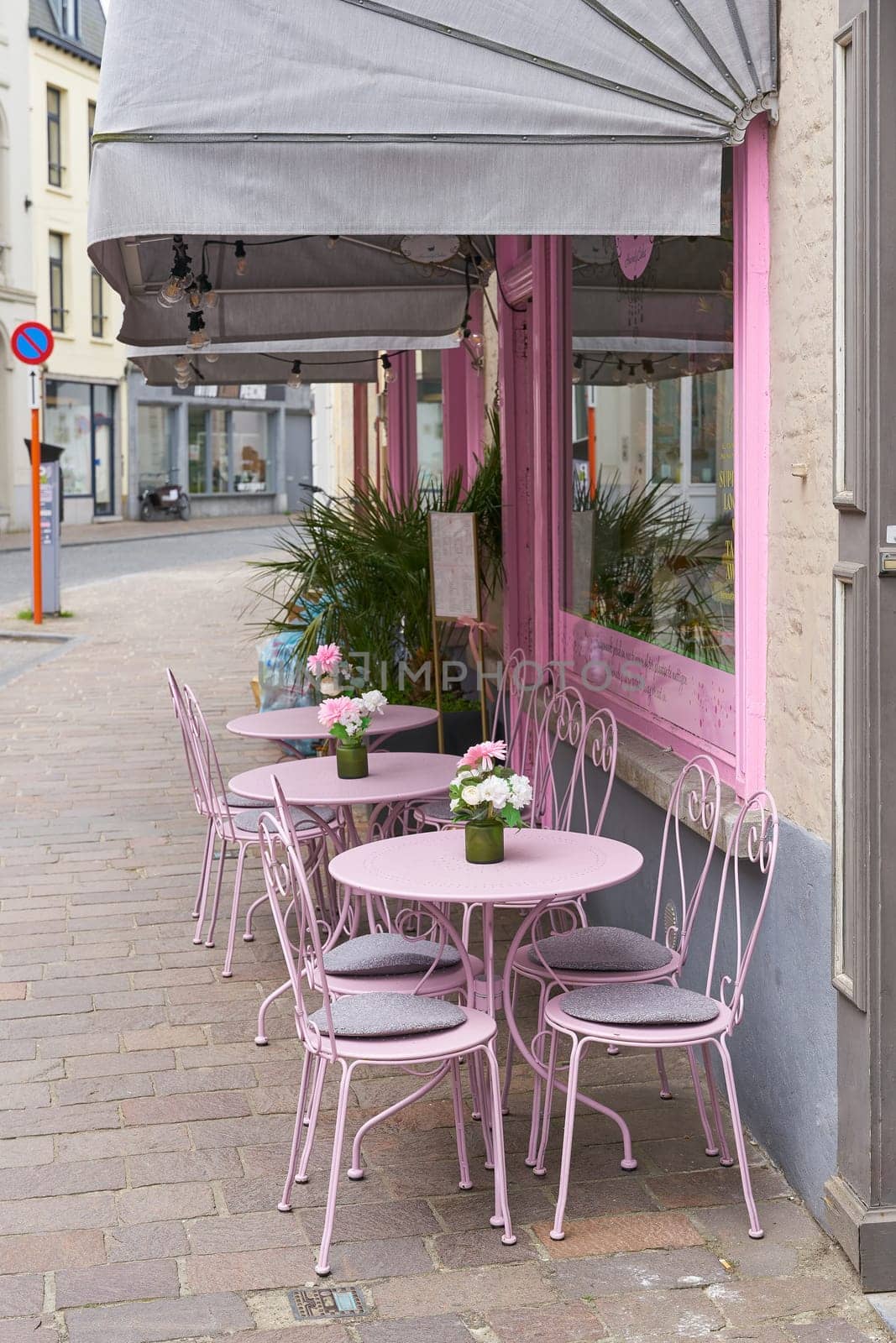 Empty chairs in front of a street cafe in the old town of Bruges in Belgium