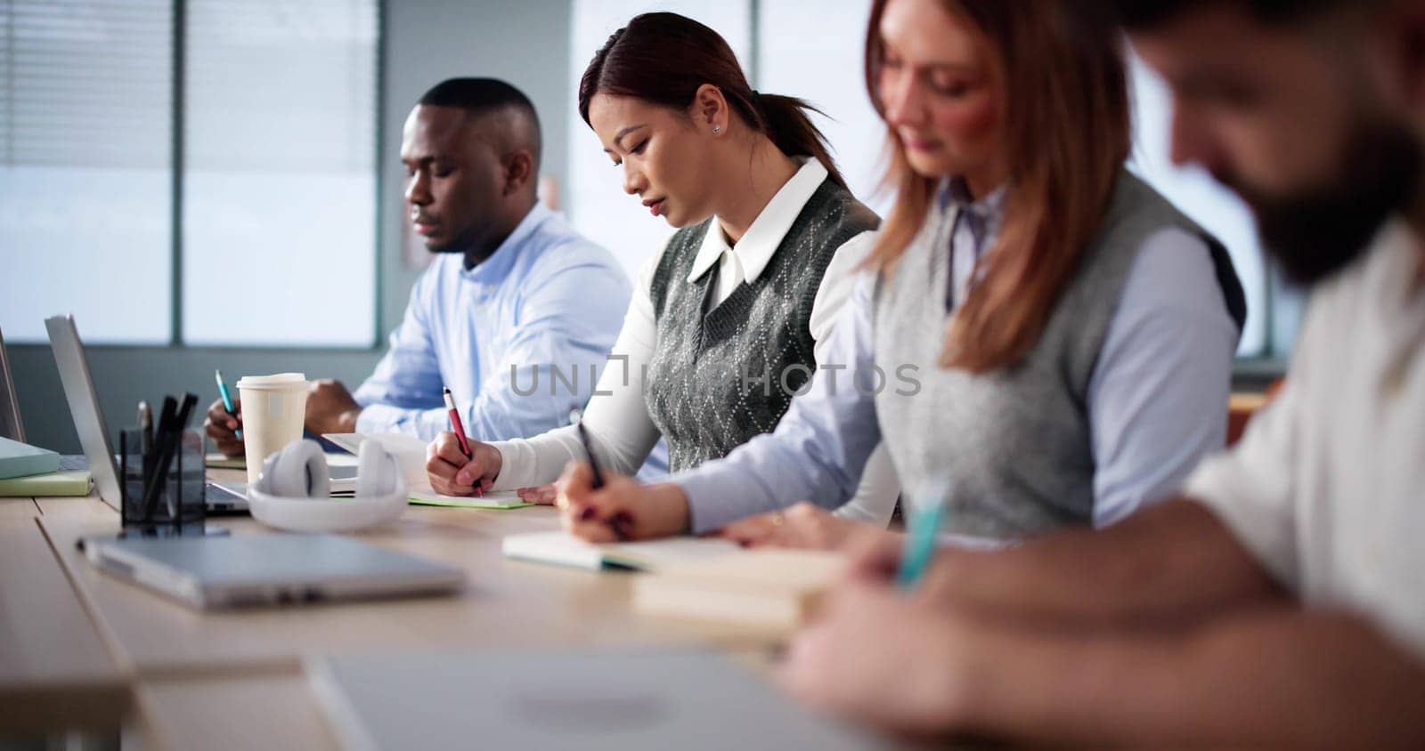 Studying In Classroom At Campus. Students Writing In Class