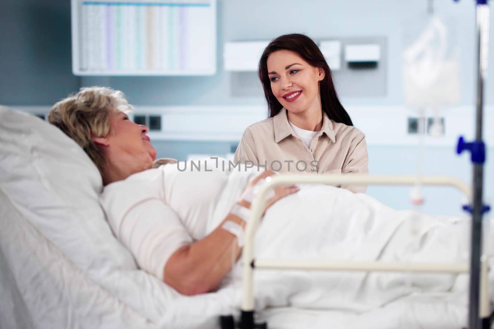 Patient In Hospital Visit By Family. Daughter Visiting Older Mother