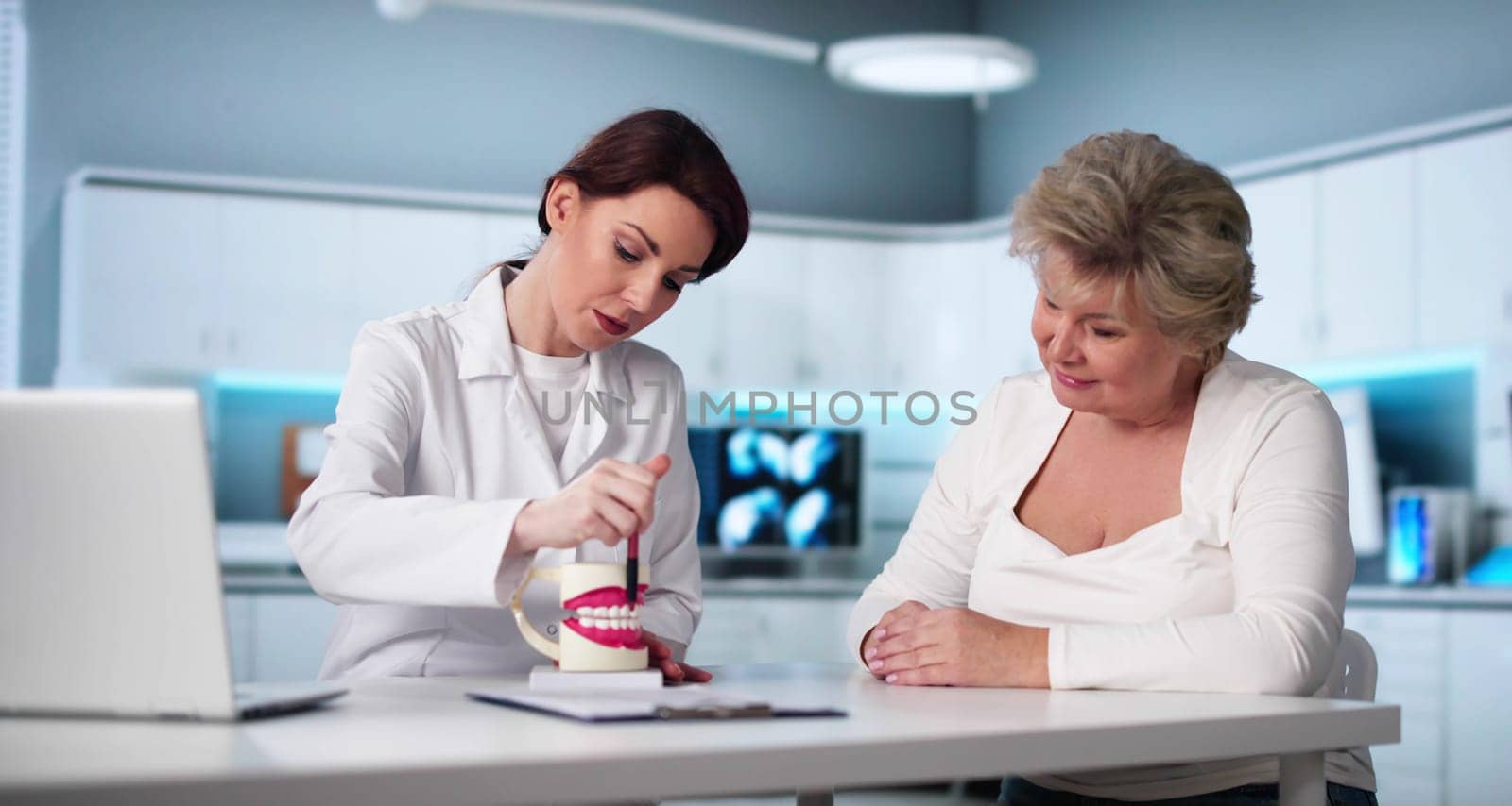 Older Patient Visiting Dental Implant Center For Treatment Consultation