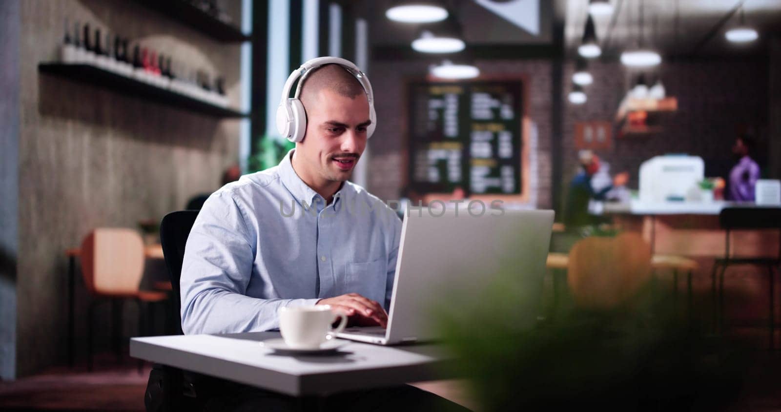 Man Using Business Laptop Online With Headset