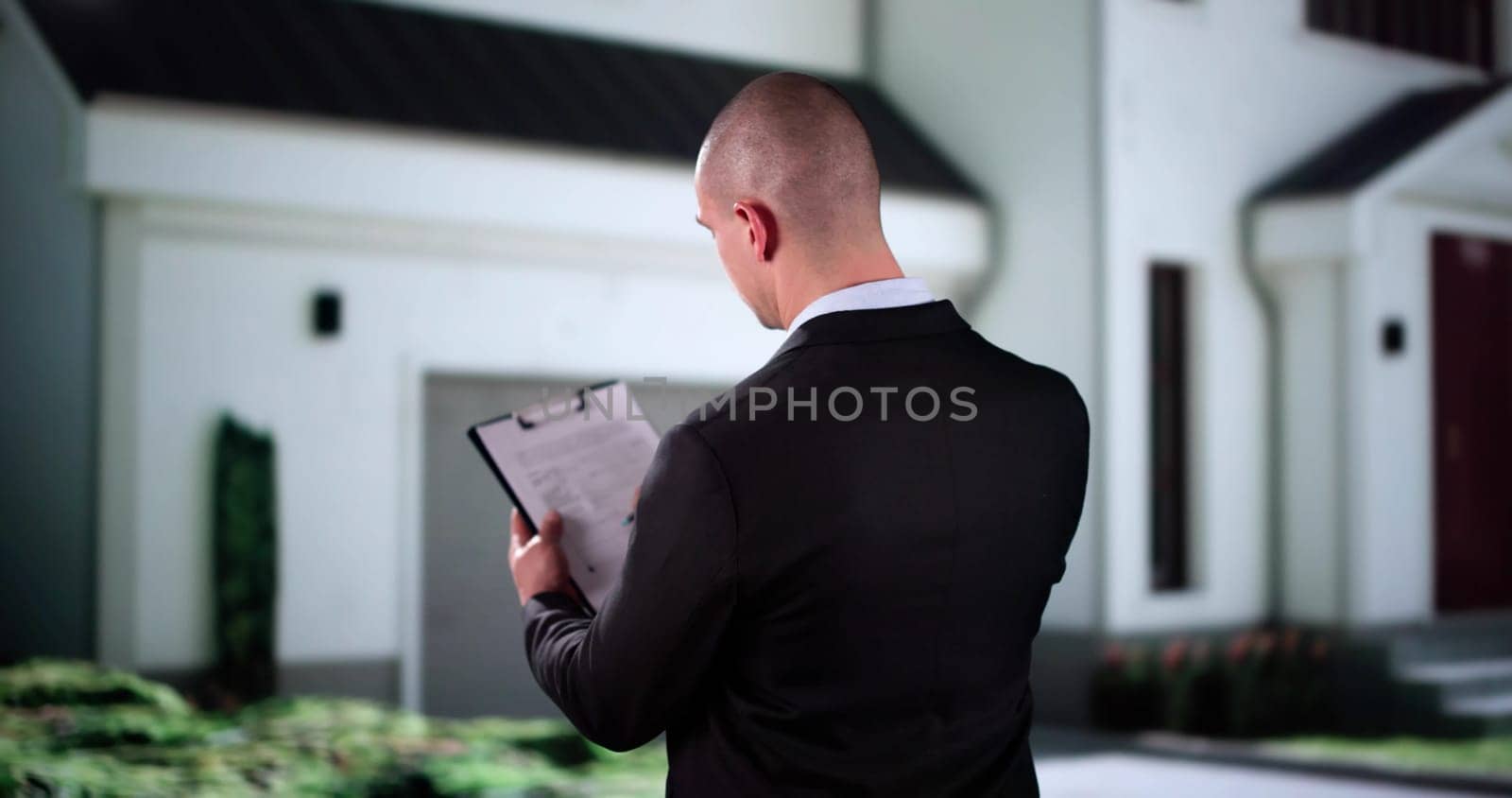 Real Estate Property Appraisal. Man Inspecting House