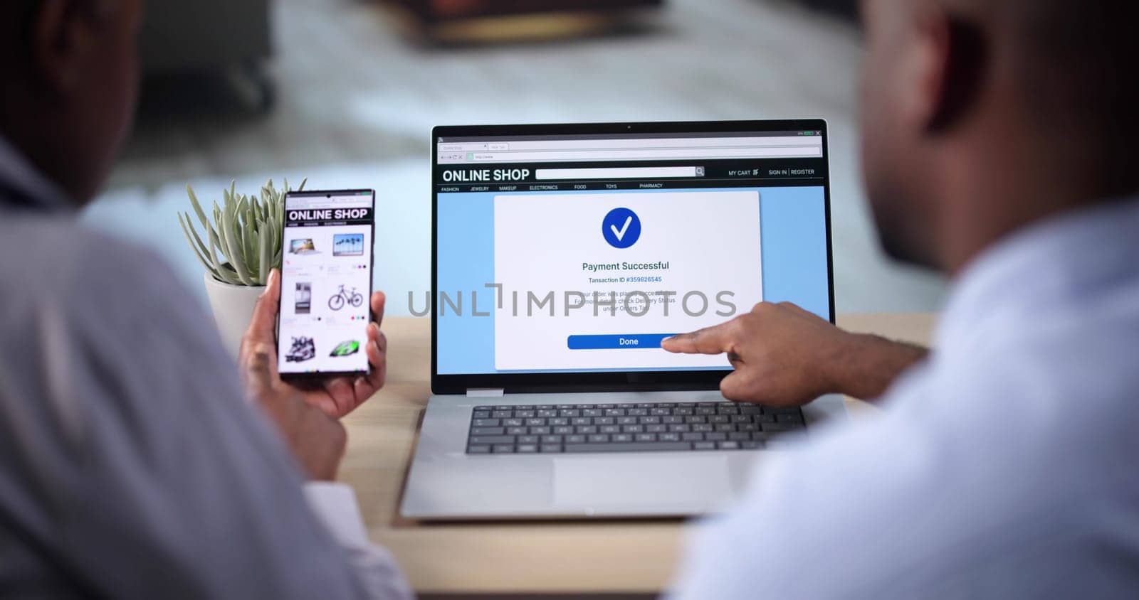 African Woman And Man Doing Online Shopping On Laptop At Home