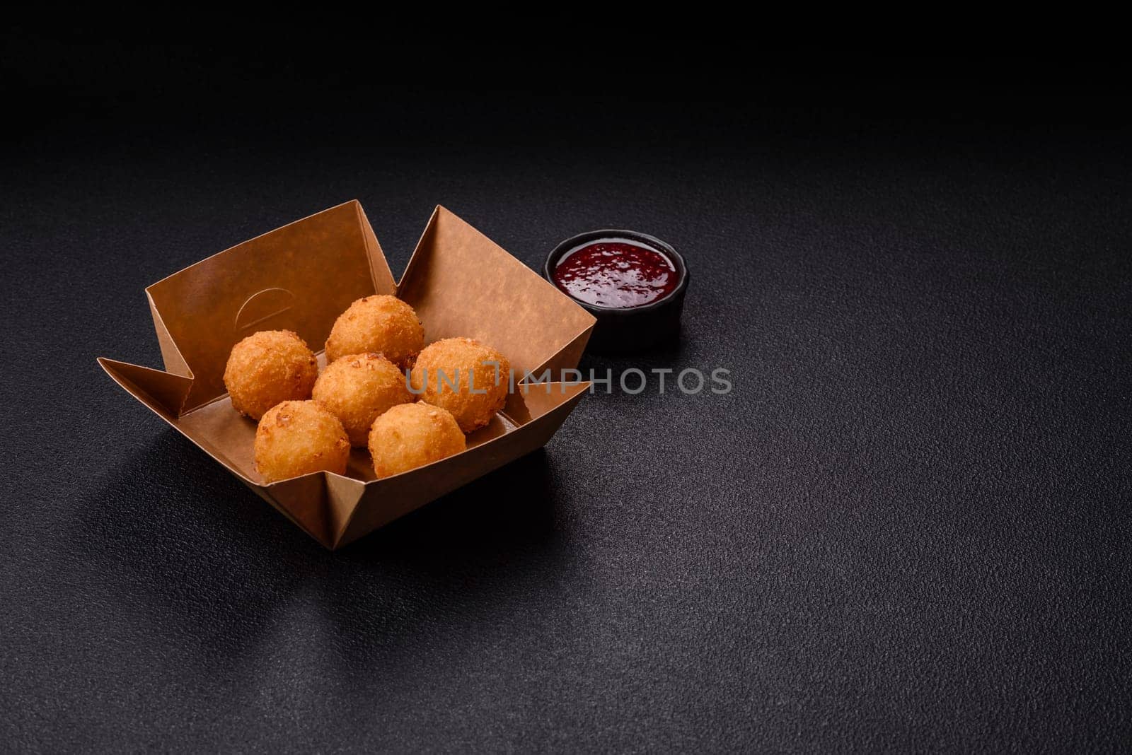 Crispy French fries with camembert or mozzarella cheese with cranberry or raspberry sauce