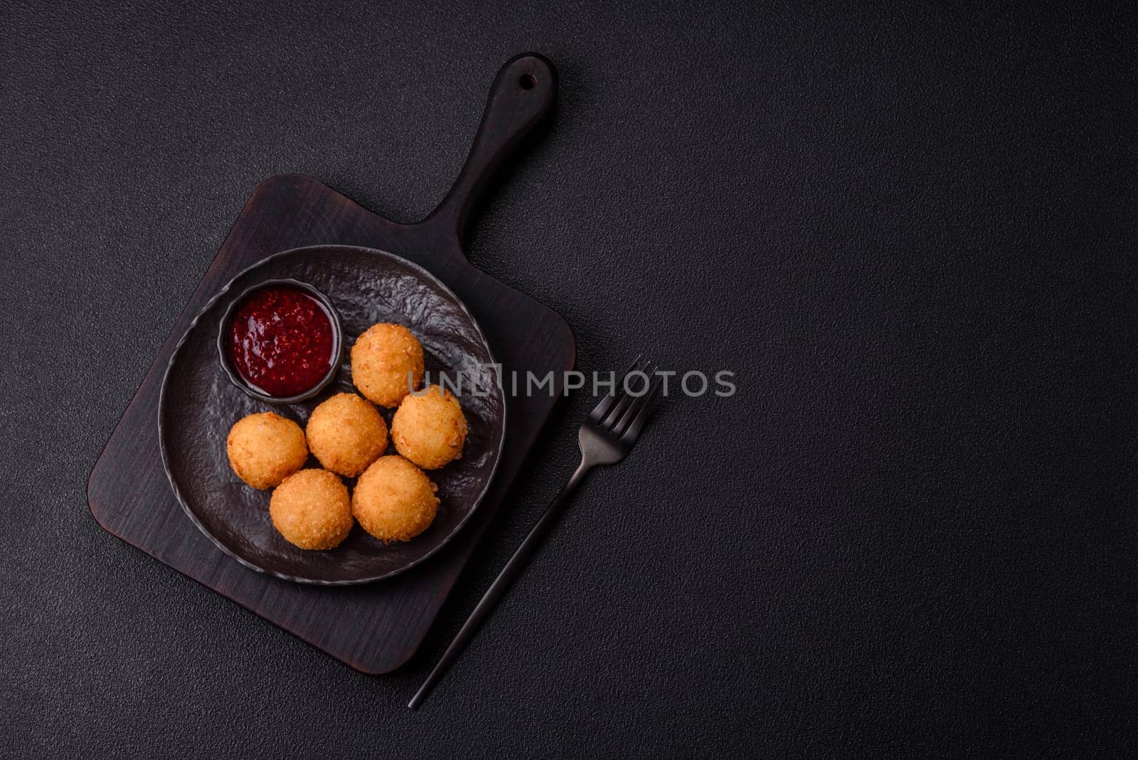 Crispy French fries with camembert or mozzarella cheese with cranberry or raspberry sauce