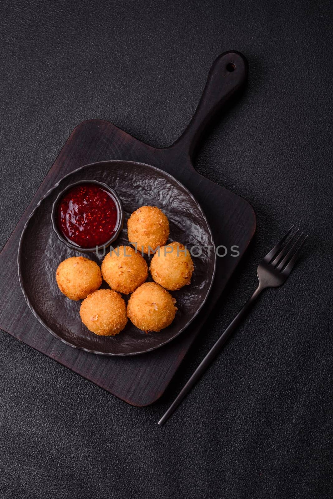 Crispy French fries with camembert or mozzarella cheese with cranberry or raspberry sauce