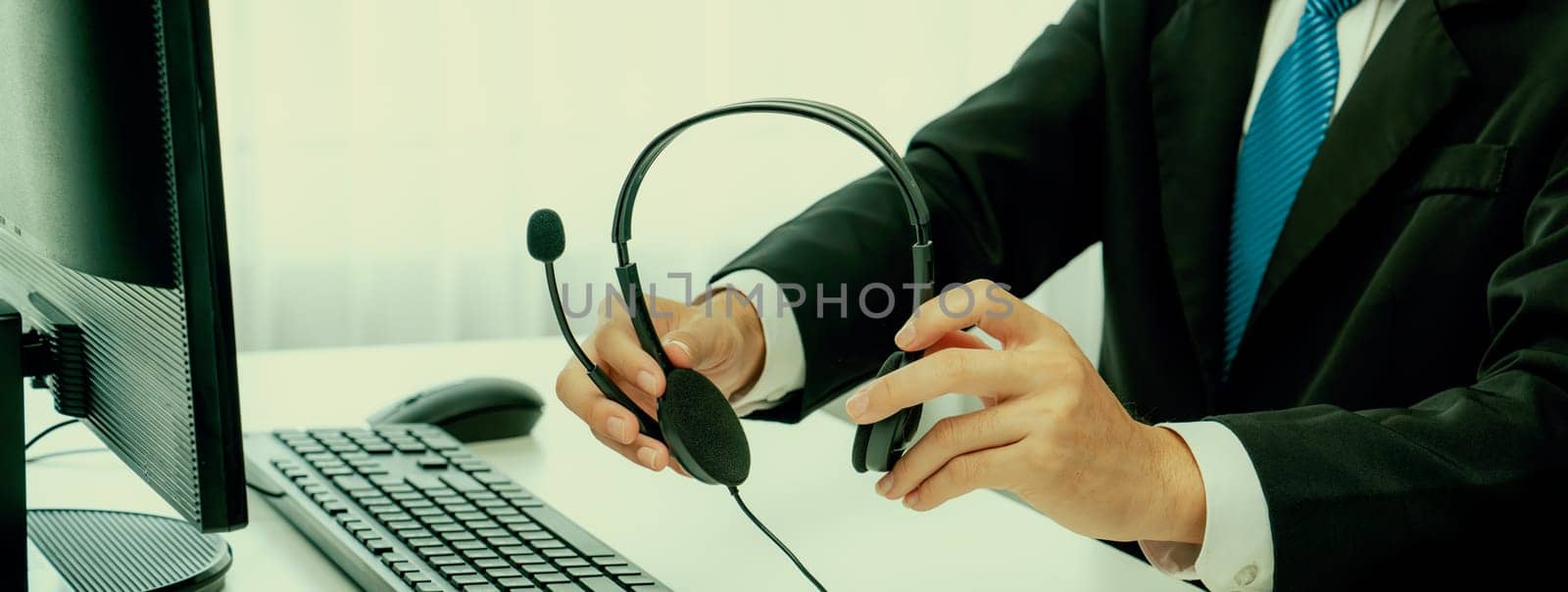 Call center wearing headset working in office for customer support oratory by biancoblue