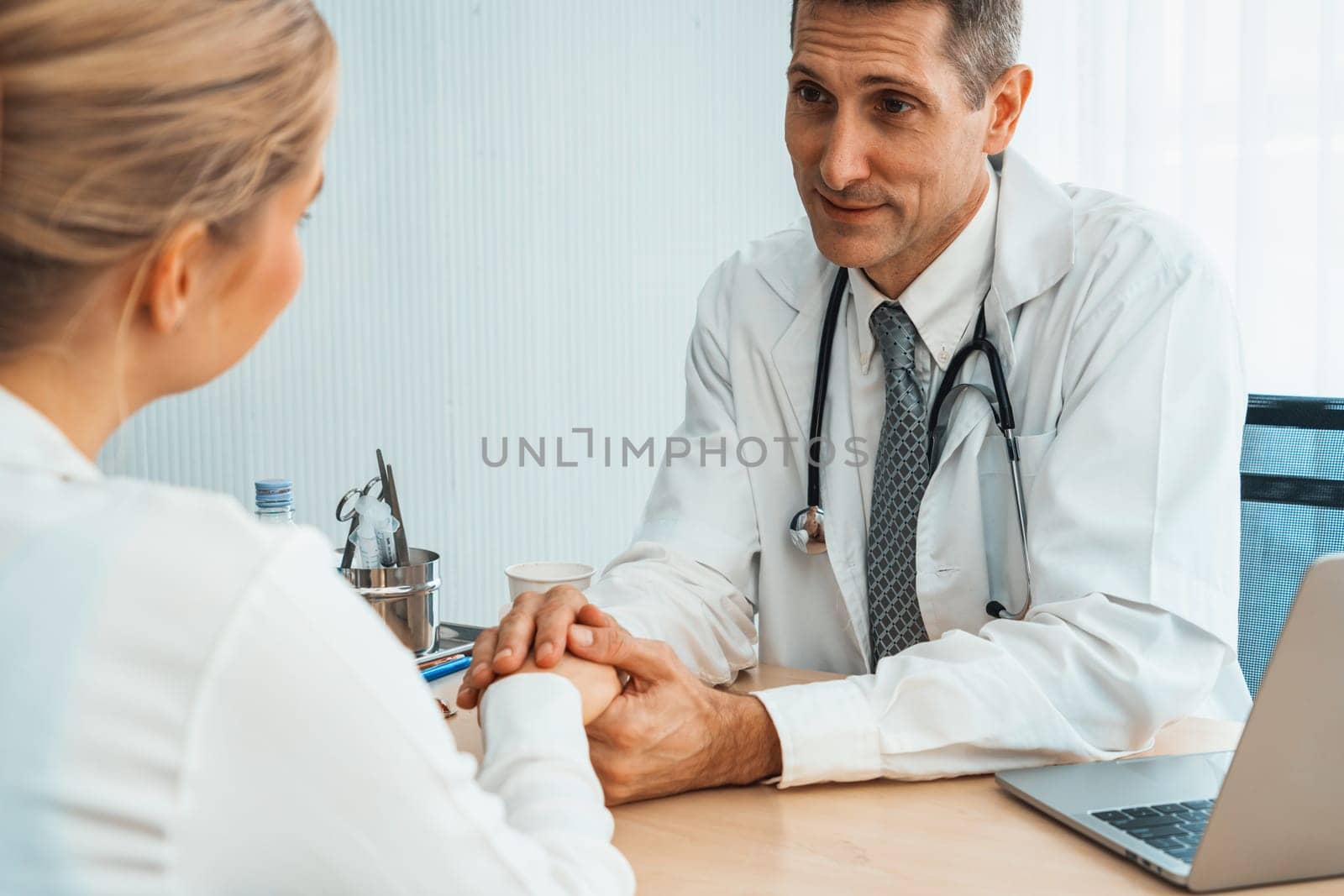 Doctor in professional uniform examining patient at hospital Jivy by biancoblue