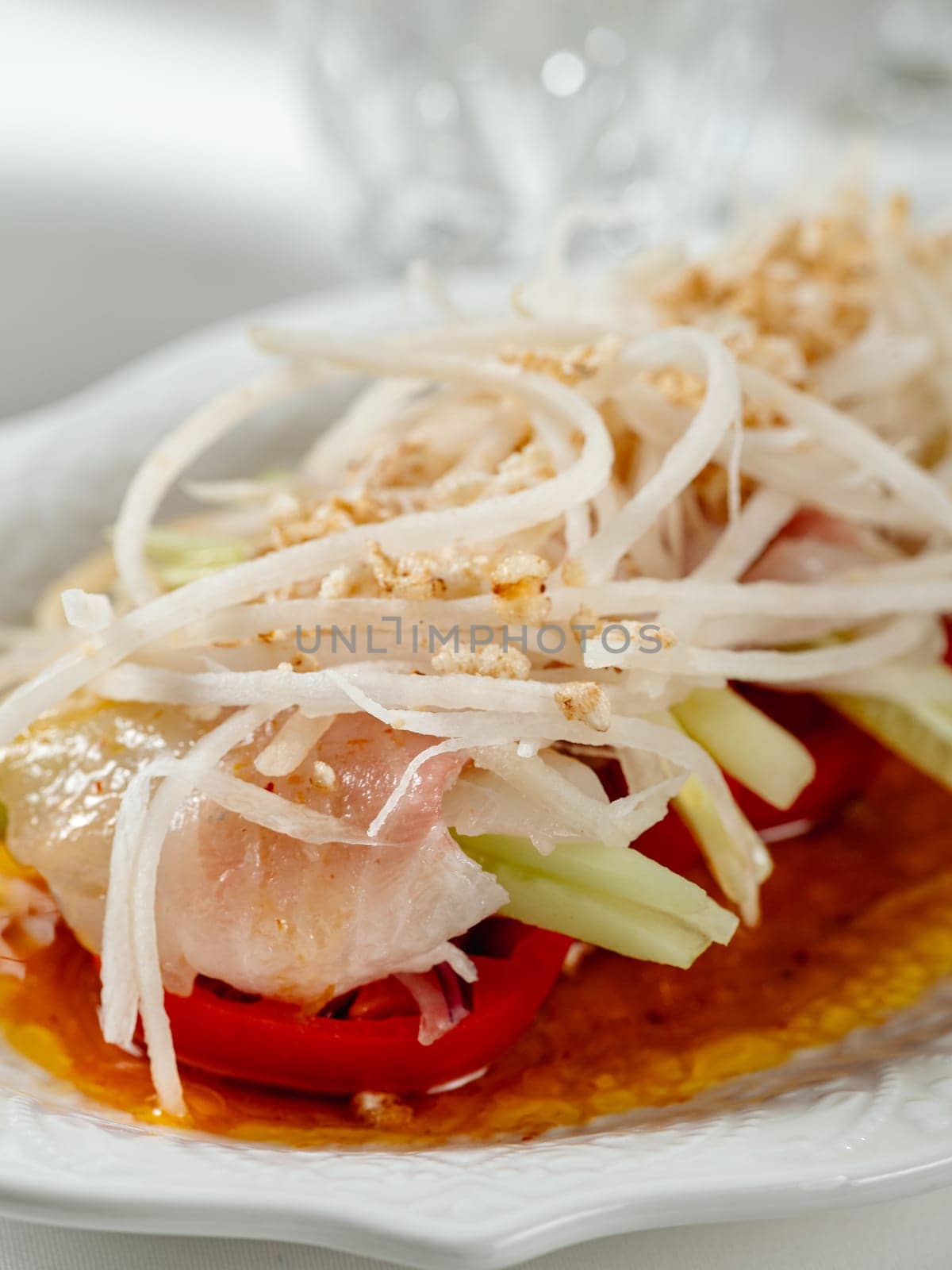 Sophisticated Fish ceviche in modern restaurant interior. Ceviche or Cebiche is a fish dish of the cuisine of Peru