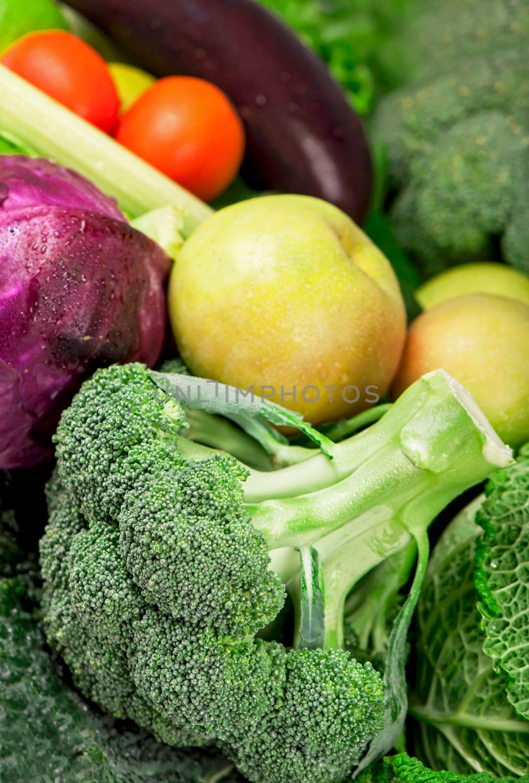 Broccoli and other fresh green vegetables make up a colorful food background by aprilphoto