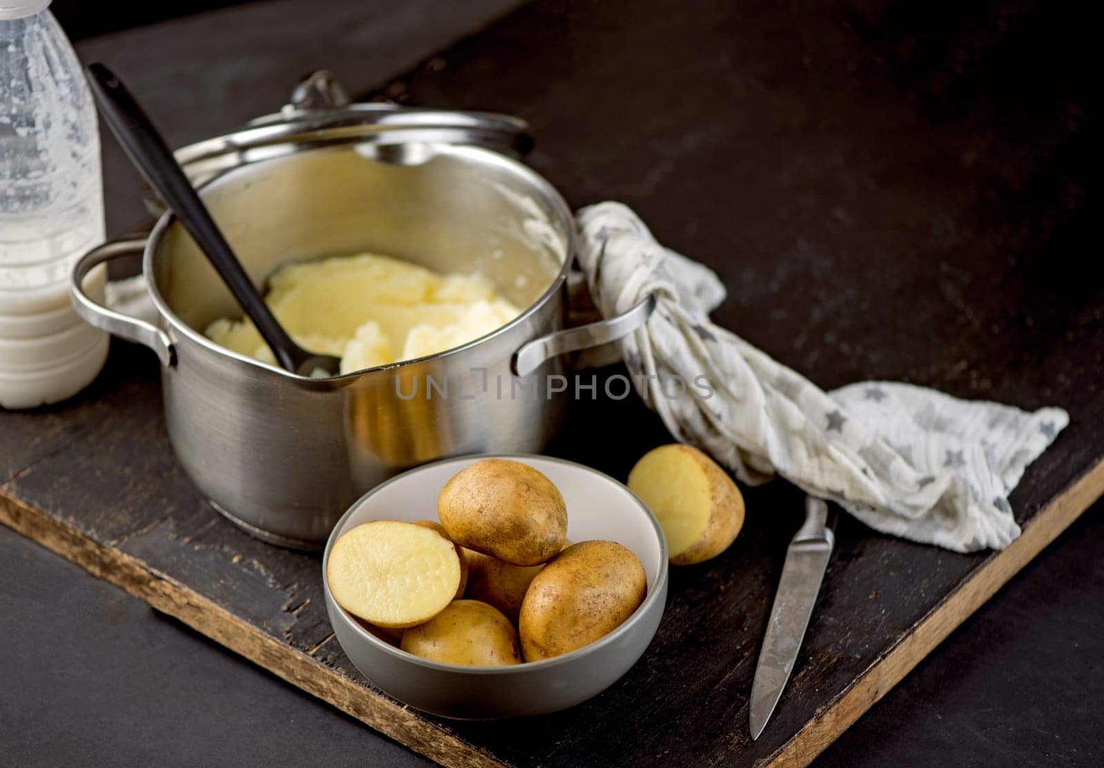 mashed potatoes in a saucepan. fresh organic mashed potatoes on a wooden table by aprilphoto