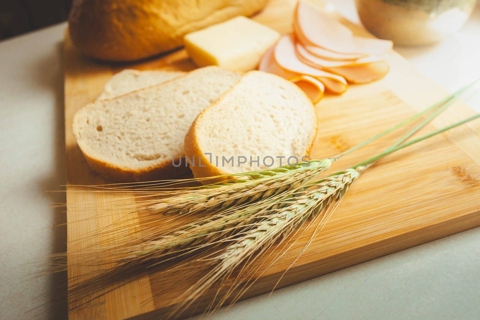 Slices of bread next to ears of grain by darekb22