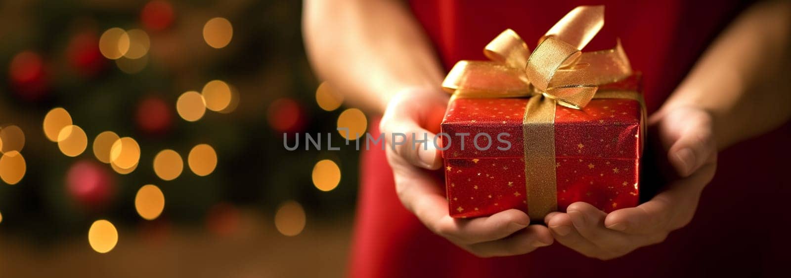New Year and Christmas background. Female hands holds gift with red ribbon Front view, web banner. Close up hands holding present. Birthday,Christmas,Mothers Day Holiday concept Festive