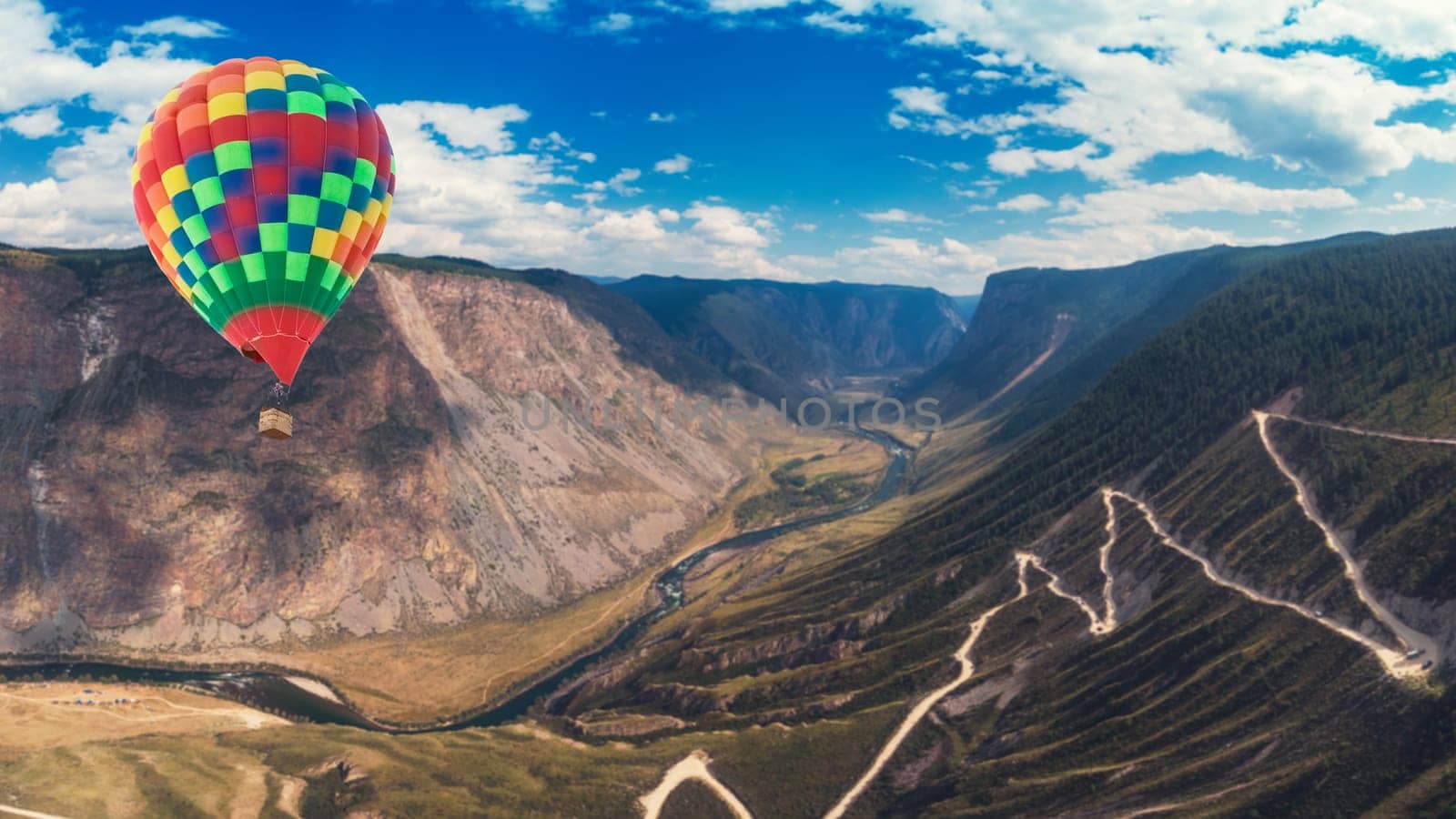 Hot air balloon above of the Katu Yaryk mountain pass and the valley of the river of Chulyshman. Altai Republic, Russia, beautiful summer day