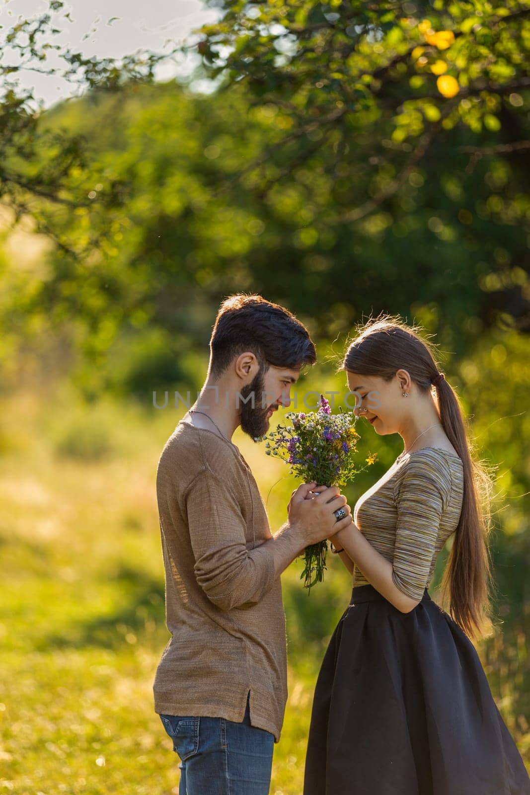 couple in nature with wildflowers by zokov