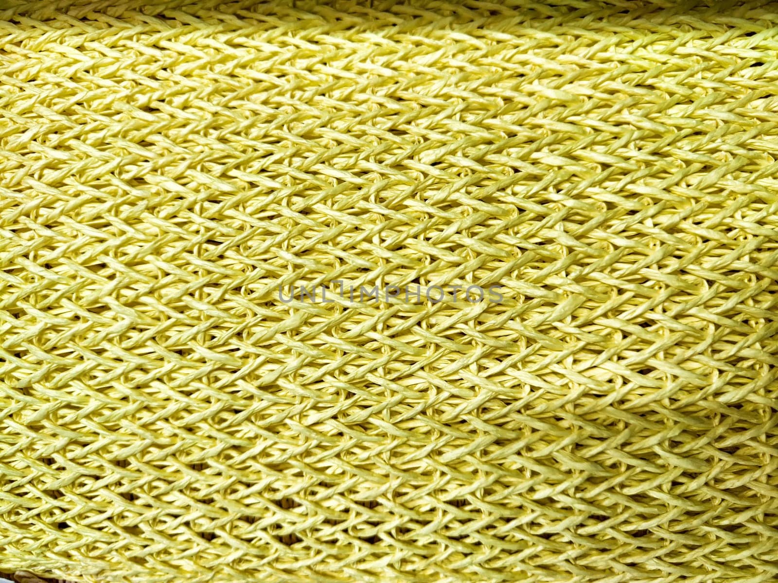 A woven yellow fabric showcases a detailed texture and pattern, providing a vibrant backdrop for text and creative projects.