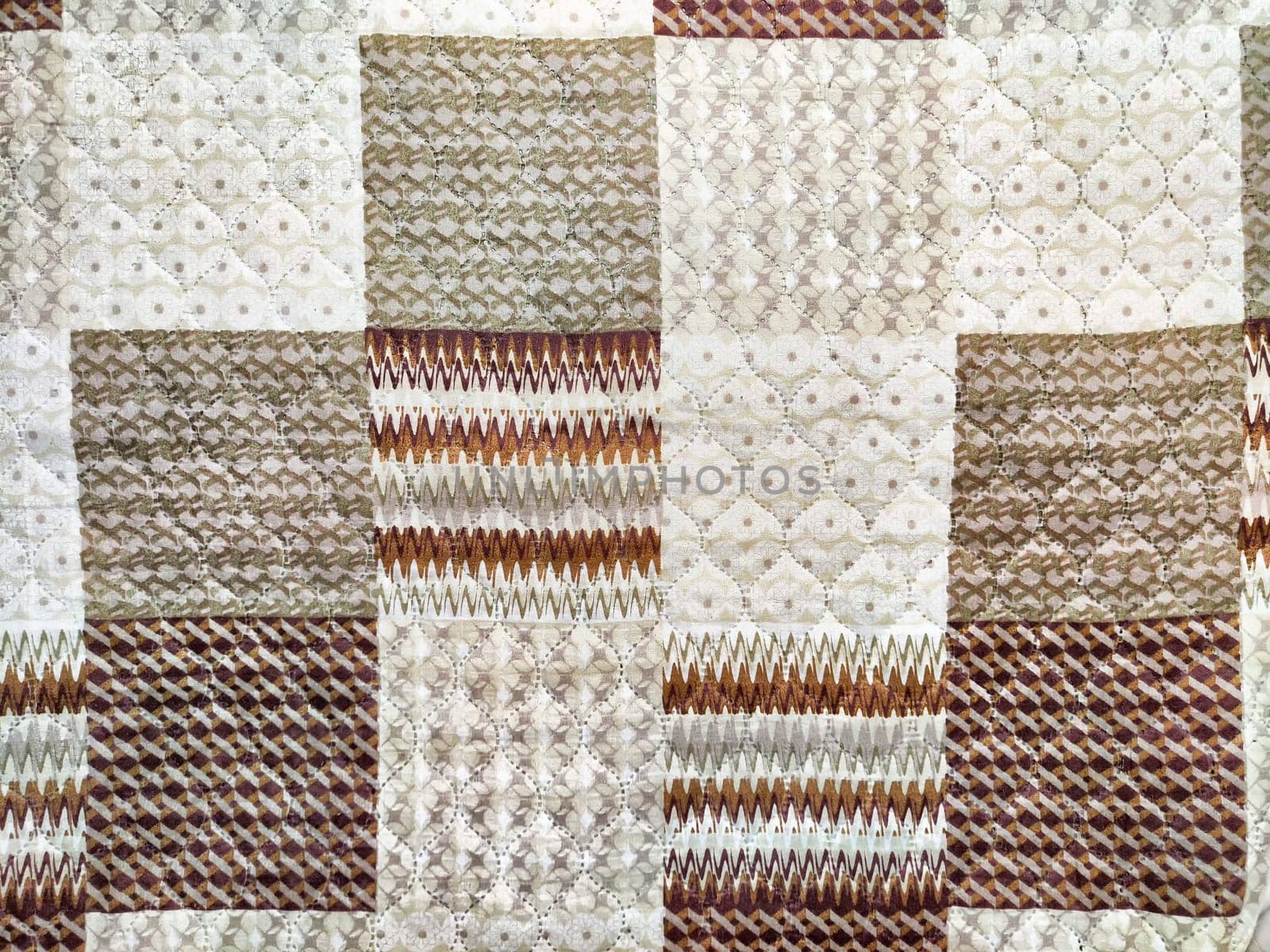 This quilt showcases a blend of intricate textures and patterns, ideal for adding warmth and style to any space.