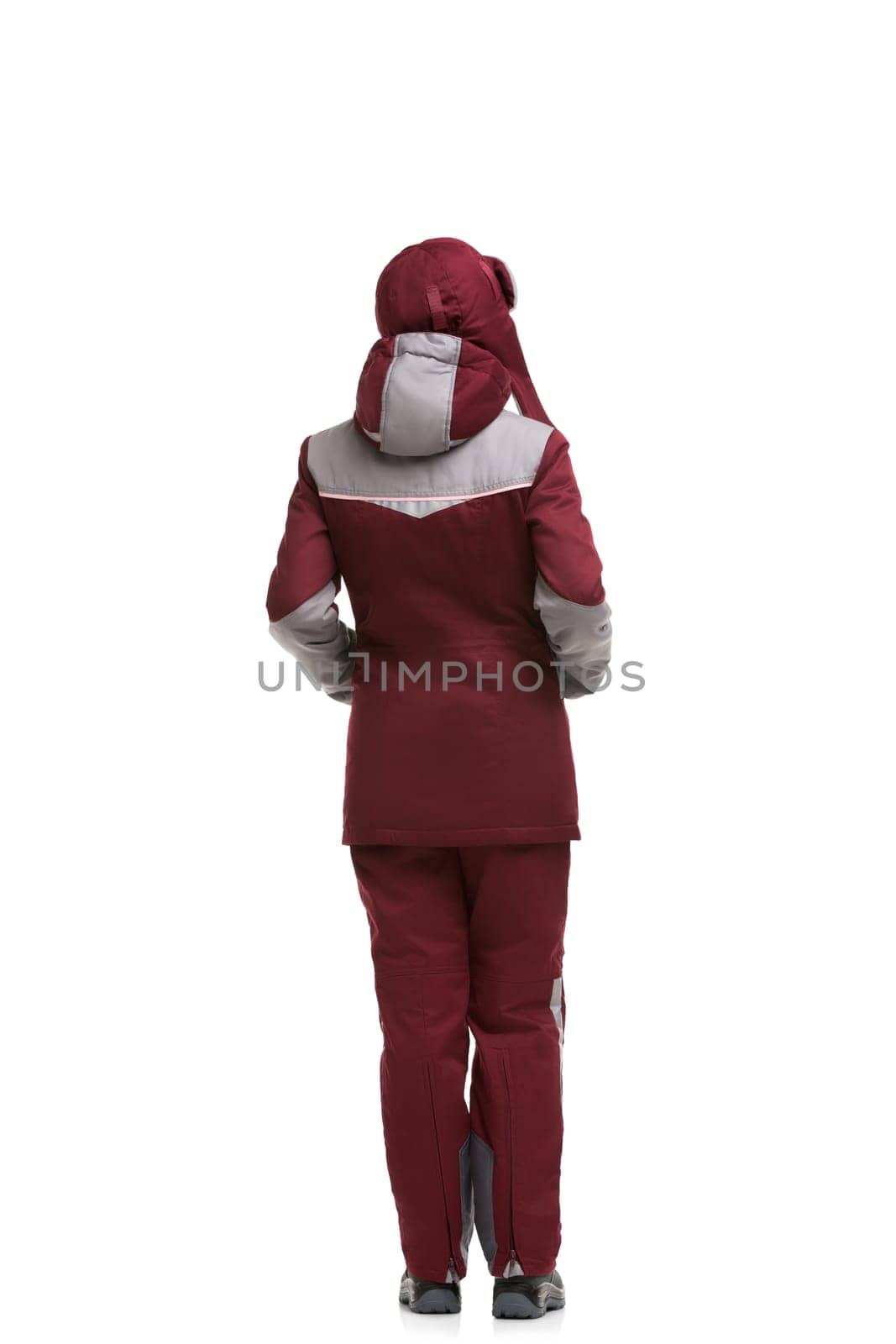 Girl in burgundy and gray working winter clothes and cap isolated full-length rearview