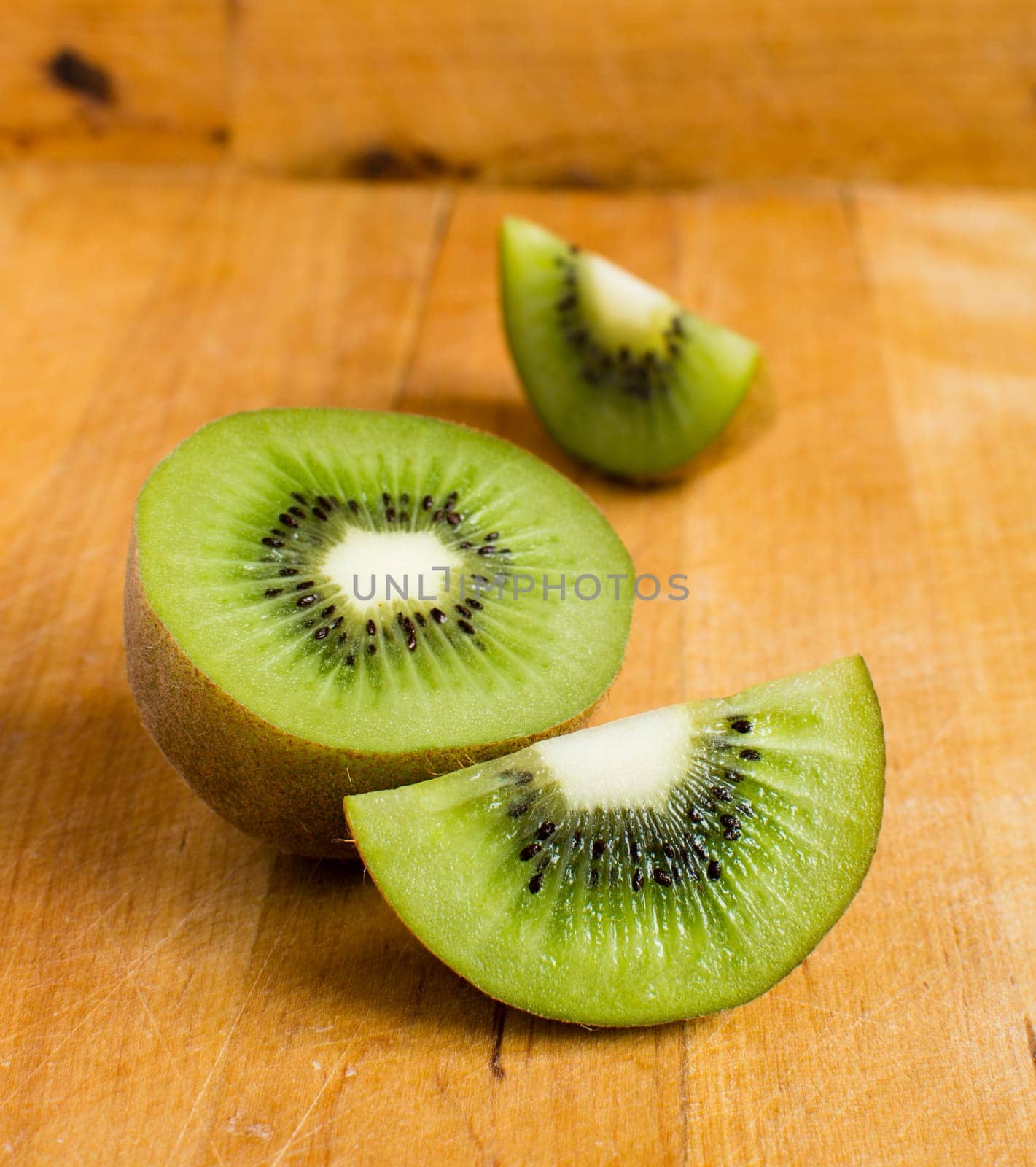 Fresh kiwis on wooden ground