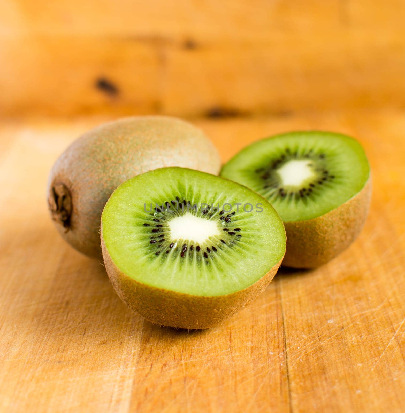 Fresh kiwis on wooden ground