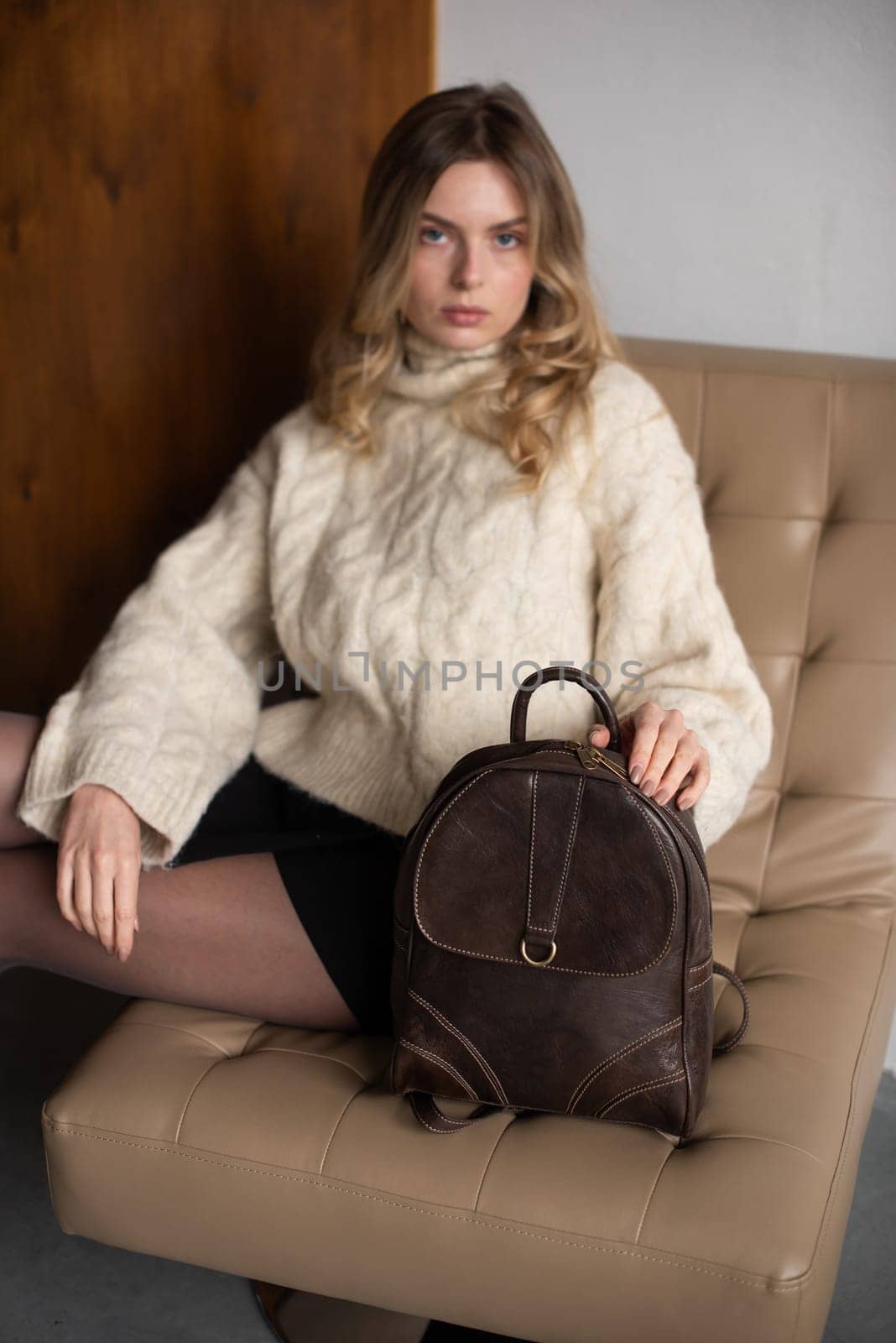 photo of a brown leather backpack with retro look. indoors photo