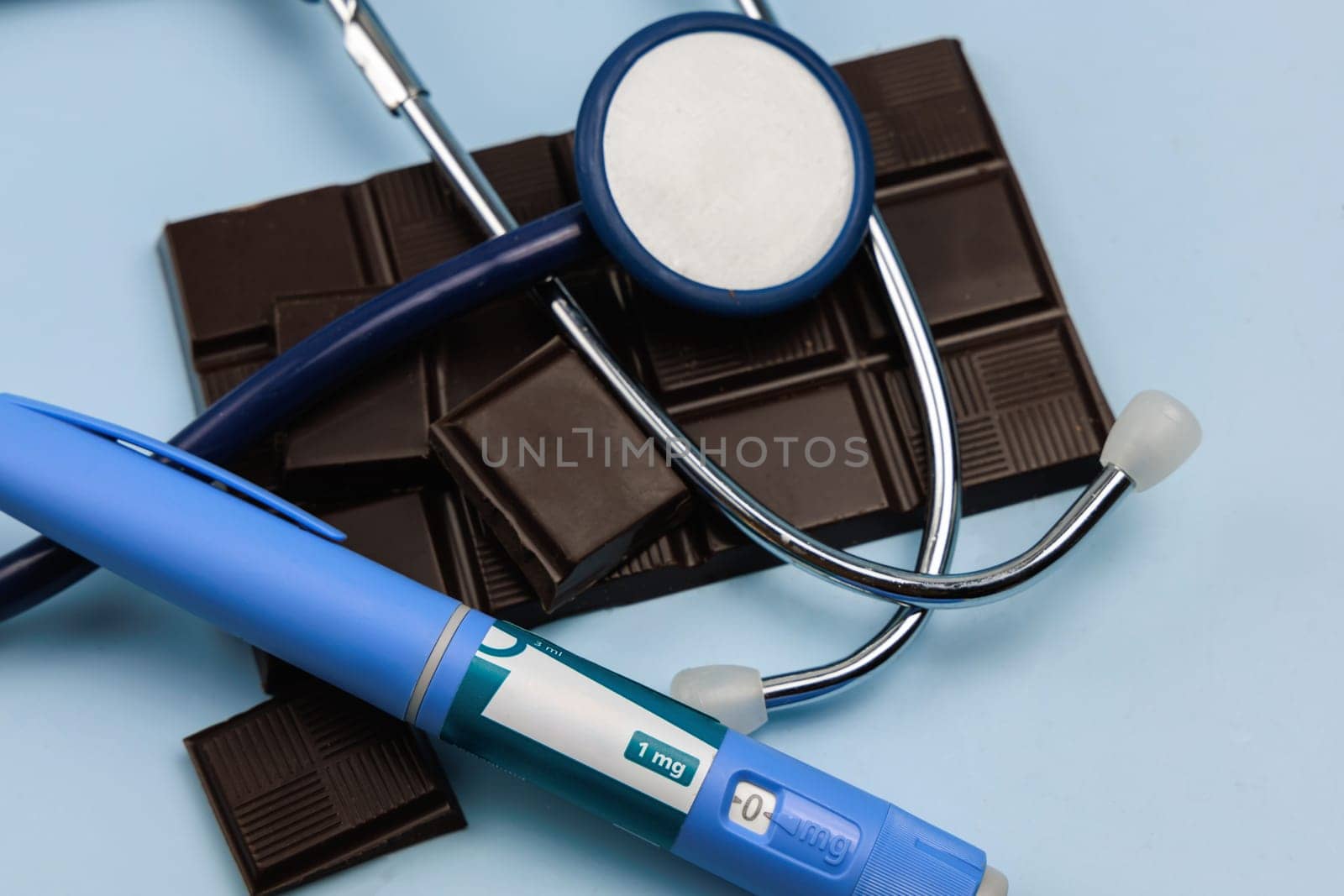 Insulin injection pen and dark chocolate for diabetics and weight loss. High quality photo