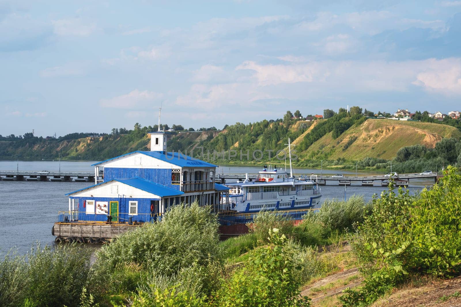 Pavlovo, Nizhny Novgorod Region, Russia - 07.17.2024. Landing stage with a tourist boat on the Oka River.