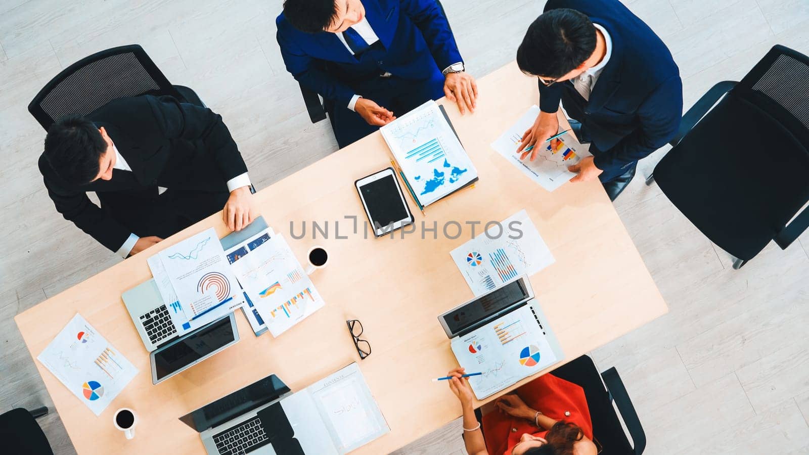 Business people group meeting shot from top view in office . Profession businesswomen, businessmen and office workers working in team conference with project planning document on meeting table . Jivy