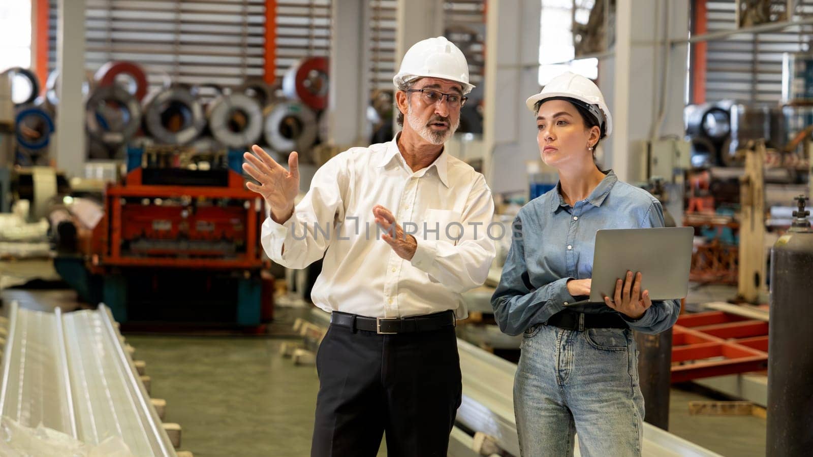 Factory manager or executive make visit metalwork manufacturing factory tour and inspect heavy steel industrial machinery showcase leadership quality as engineering inspection supervisor. Exemplifying