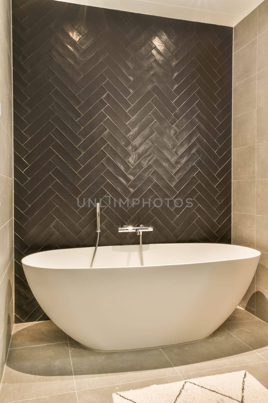 a bathroom with a bath tub and a tile wall by casamedia