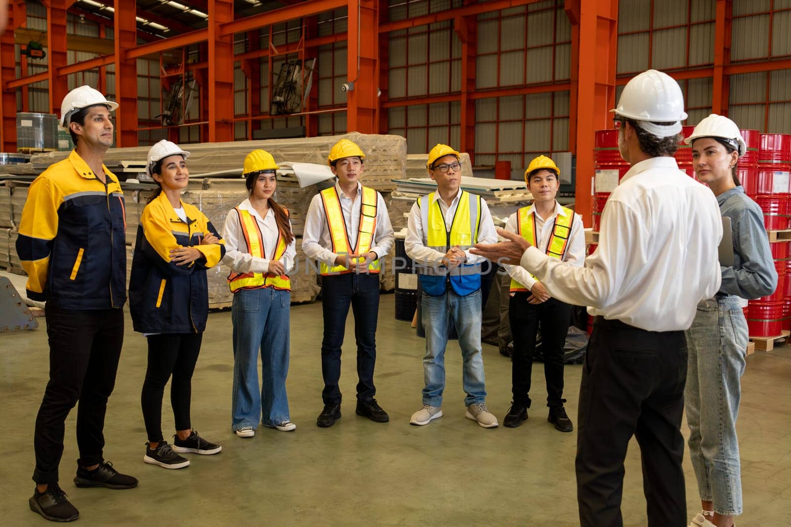 Collective factory worker and engineer gather for meeting with factory executive or manager, discussing plan and industry training program on-site work heavy industrial steel workshop. Exemplifying