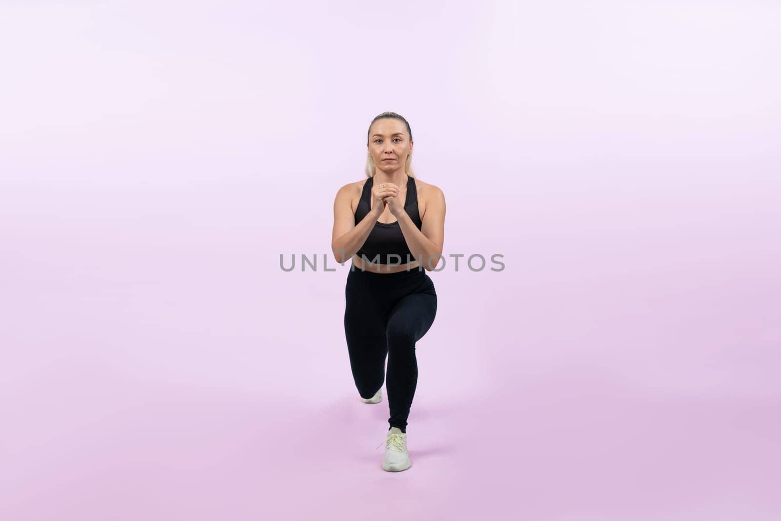 Active and fit physique senior woman warming up before exercise on isolated background. Healthy lifelong senior people with fitness healthy and sporty body care lifestyle concept. Clout